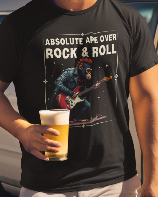 Person wearing a black t-shirt with a graphic of an ape playing guitar and text 'Absolute Ape Over Rock & Roll', holding a beer.